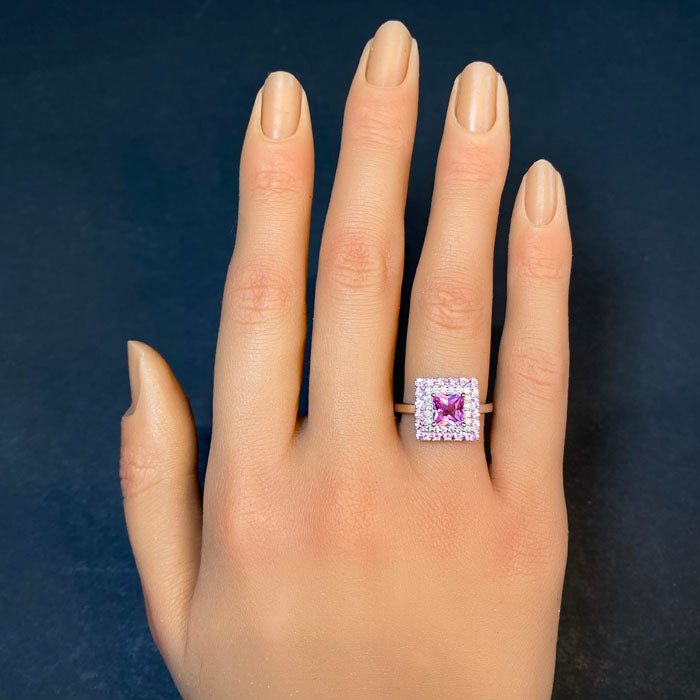 pink sapphire ring in platinum with diamonds on hand