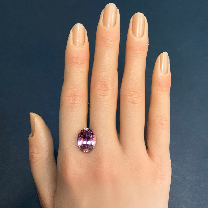 oval pink tourmaline on hand