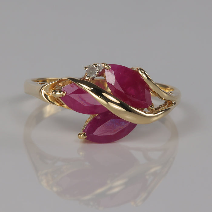 Marquise ruby gem ring with diamond accent in yellow gold
