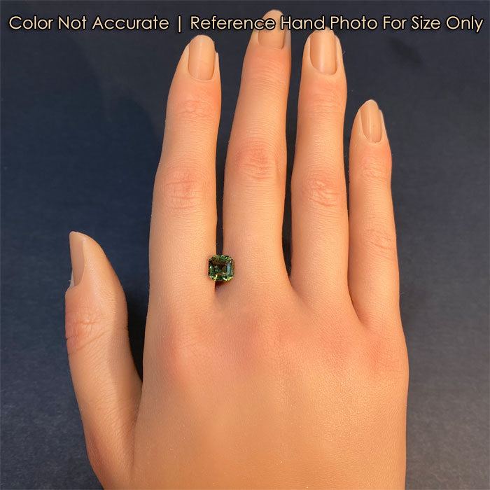 sapphire green gemstone on hand 