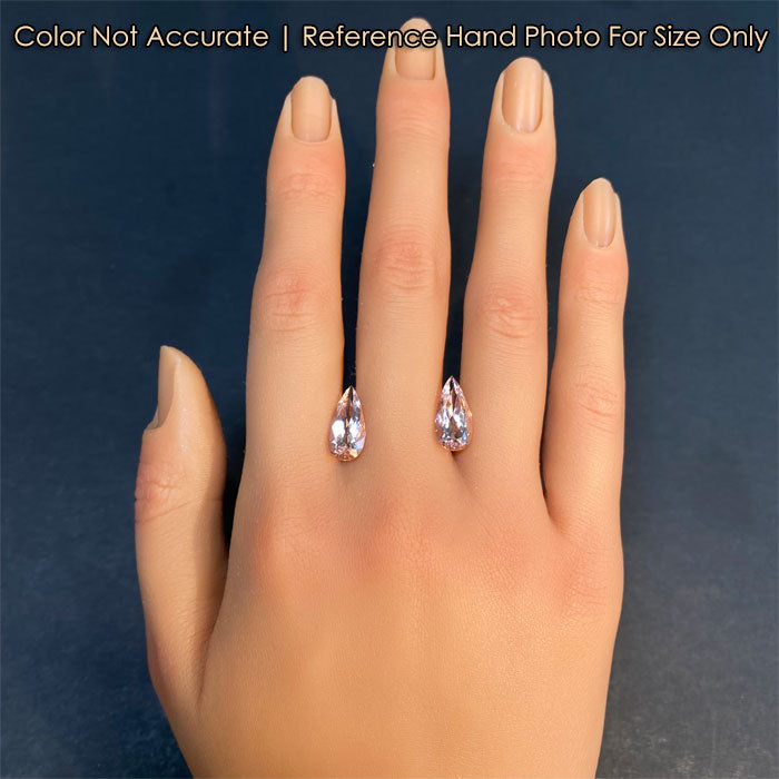 peach color pair of morganite gems on hand 