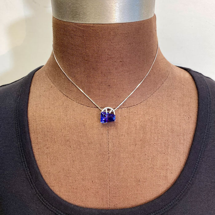 White gold and tanzanite gemstone pendant on form