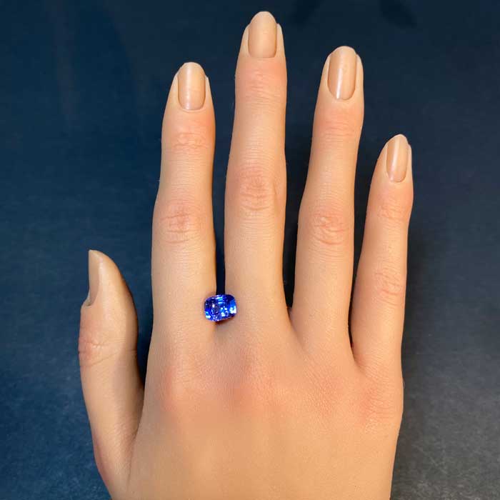 sapphire gemstone on hand violet blue