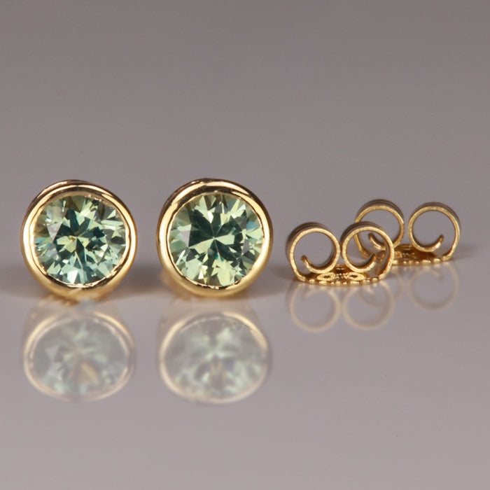 light green bezel set sapphire stud earrings