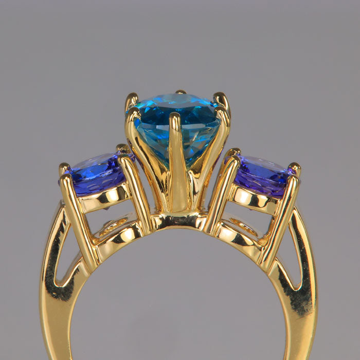 blue zircon tanzanite gemstones in yellow gold ring