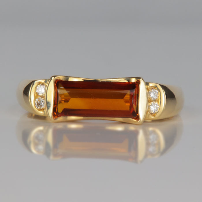 deep golden orange citrine gemstone ring with diamonds in yellow gold