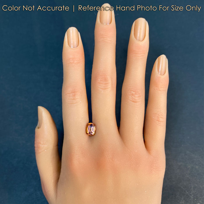 orange pink tanzanite gemstone on hand 