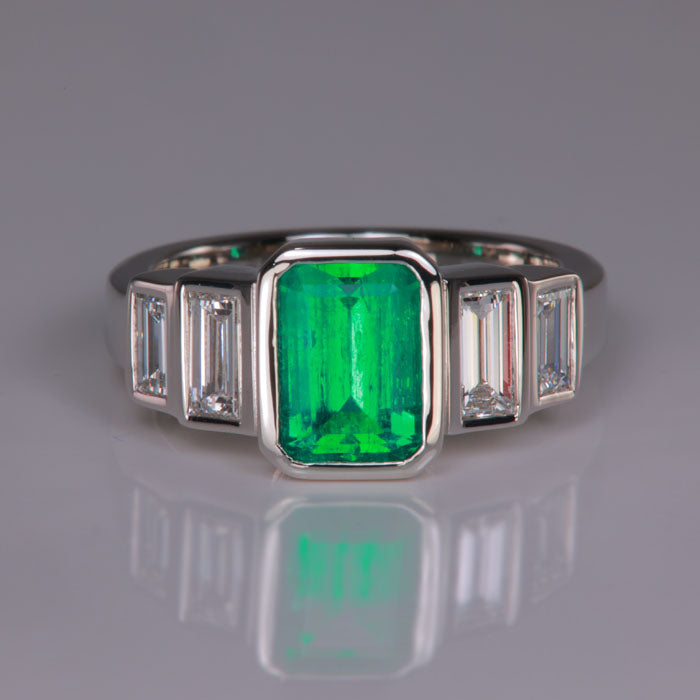 emerald cut emerald in platinum with diamond accents ring