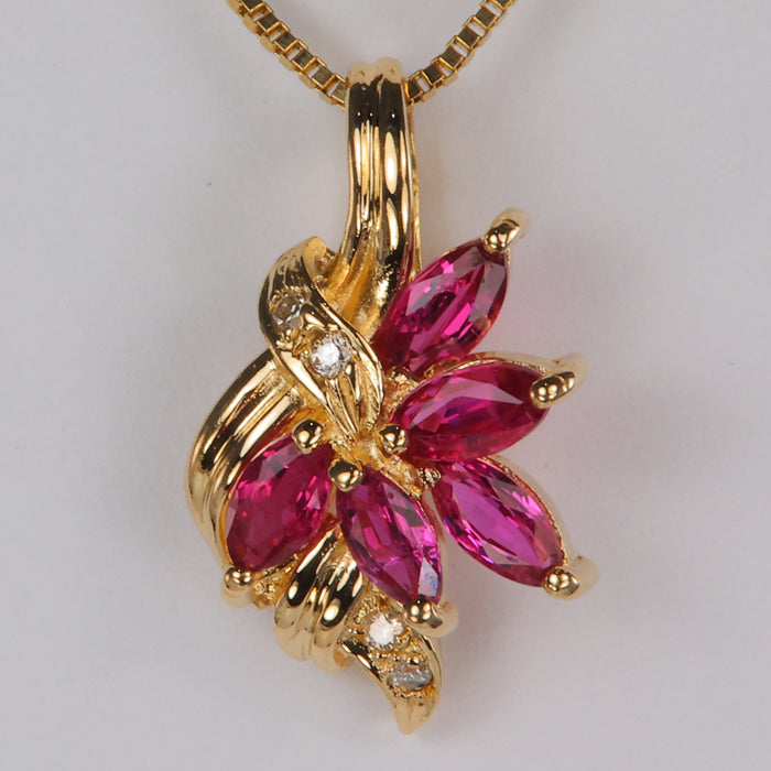 ruby gemstone and diamond accented gold pendant