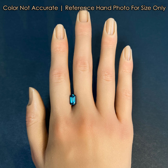 emerald cut sapphire gemstone on hand