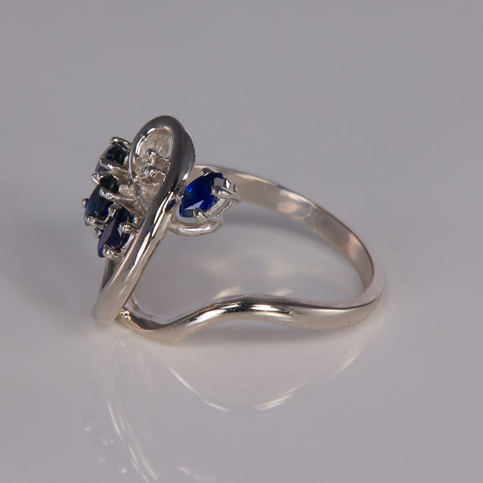 white gold ring with sapphires and a diamond accent