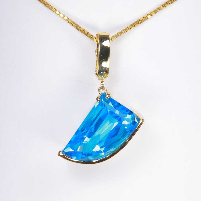 blue topaz statement pendant in yellow gold