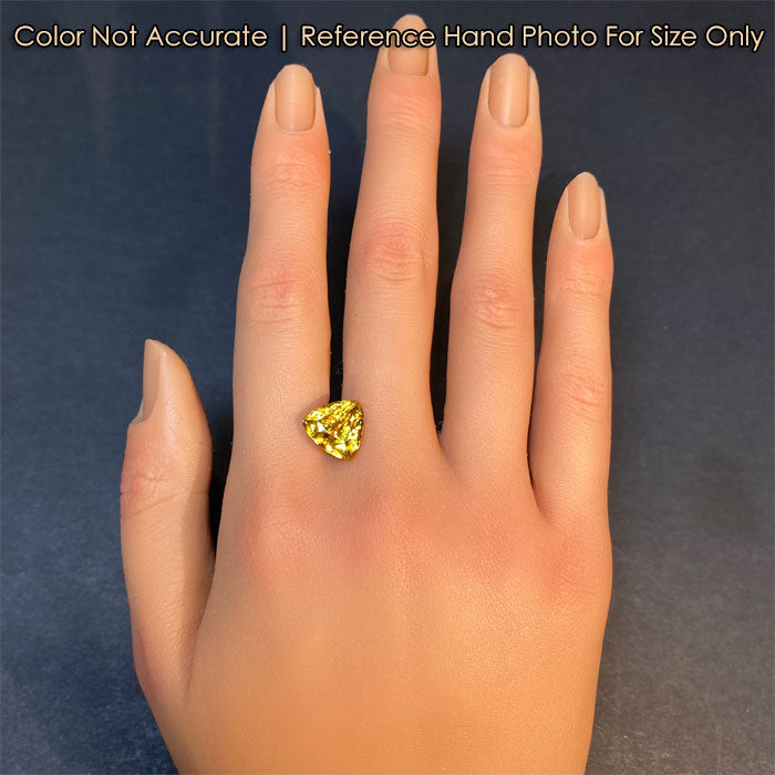 golden yellow sphene gemstone on hand 