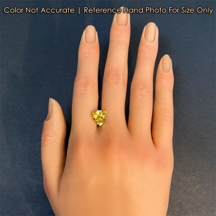 golden yellow beryl heliodore gemstone on hand 