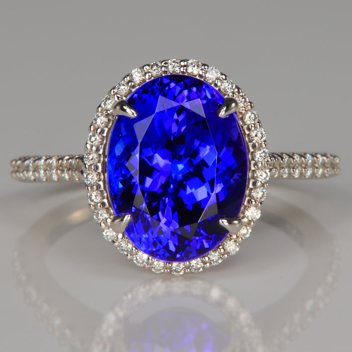 beautiful blue violet tanzanite gemstone ring with diamond halo in 18k white gold 