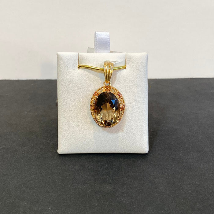 oval cut smoky quartz and spessartite garnet pendant in yellow gold