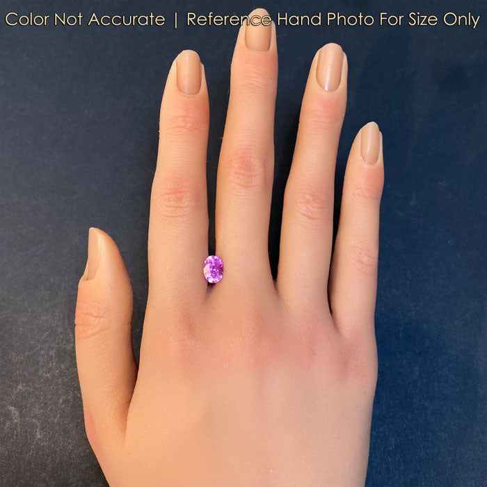 oval cut pink sapphire gem on hand 