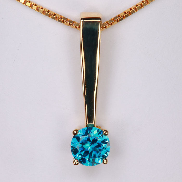 greenish blue zircon gemstone pendant in yellow gold