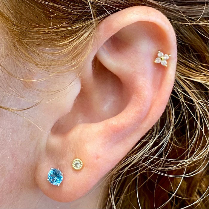 blue zircon studs on ear