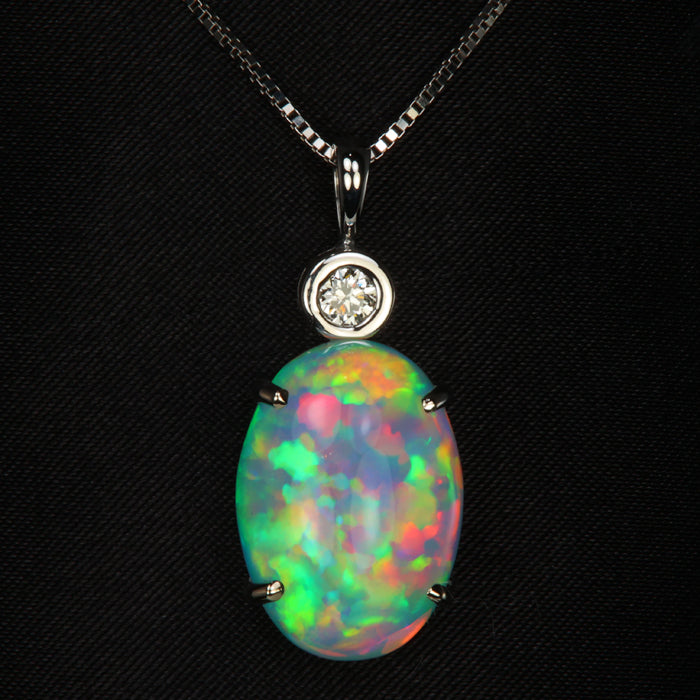 oval cabochon cut opal pendant in white gold with diamond